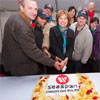 Premier Christy Clark cuts cake celebrating MGC client Seaspan's success
